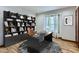 Office space with built-in shelving, work desk and a window for natural light at 11612 E Cornell Cir, Aurora, CO 80014