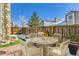 Charming patio with brick accents, a dining set, grill and a well-kept lawn at 11612 E Cornell Cir, Aurora, CO 80014