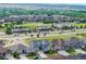 An aerial view of a residential community with lush greenery, well-maintained roads, and mountain views at 12953 Bridge View Ln, Parker, CO 80134