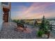 Backyard view shows lovely landscaping with a bench to enjoy the sunset at 12953 Bridge View Ln, Parker, CO 80134