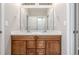 Bathroom featuring double sinks, wood cabinetry, and a well-lit mirror, perfect for a Gathering at 12953 Bridge View Ln, Parker, CO 80134