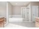 Bright bathroom featuring a soaking tub, glass shower, and a neutral color palette for relaxation at 12953 Bridge View Ln, Parker, CO 80134