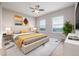 Bright bedroom with a ceiling fan, large windows, and neutral decor offers a relaxing space at 12953 Bridge View Ln, Parker, CO 80134