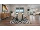 Elegant dining room with a modern table, chairs, and sliding doors leading to a balcony with scenic views at 12953 Bridge View Ln, Parker, CO 80134