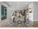 Bright dining area with a modern table and chairs, offering easy access to the kitchen and a scenic view of the outdoors at 12953 Bridge View Ln, Parker, CO 80134