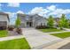 A beautifully landscaped two-story home featuring a well-manicured lawn and a three-car garage at 12953 Bridge View Ln, Parker, CO 80134