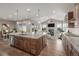 Open-concept kitchen with granite countertops, stainless steel appliances, and a center island with seating at 12953 Bridge View Ln, Parker, CO 80134