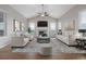 Bright living room featuring vaulted ceilings, a fireplace, and large windows for natural light at 12953 Bridge View Ln, Parker, CO 80134