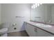 Bright bathroom with dual sink vanity, modern fixtures and wood-look flooring at 7414 S Alkire St # 101, Littleton, CO 80127