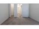 Cozy bedroom with neutral carpet flooring and a view of the hallway at 7414 S Alkire St # 101, Littleton, CO 80127