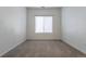 Empty bedroom with neutral carpet and a window providing natural light at 7414 S Alkire St # 101, Littleton, CO 80127