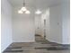 View from dining area to entrance featuring modern flooring and a pendant light fixture at 7414 S Alkire St # 101, Littleton, CO 80127