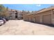 Property garages sit in front of the building with parking lot on a bright sunny day at 7414 S Alkire St # 101, Littleton, CO 80127