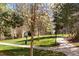 Manicured grounds with walking paths, blossoming trees, green space and well maintained landscaping at 7414 S Alkire St # 101, Littleton, CO 80127