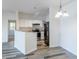 Modern kitchen adjacent to a dining area, featuring white cabinets and stainless steel appliances at 7414 S Alkire St # 101, Littleton, CO 80127