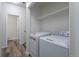 Laundry area featuring modern washer and dryer units at 7414 S Alkire St # 101, Littleton, CO 80127