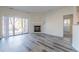 Inviting living room with fireplace, sliding door, and modern gray toned wood floors at 7414 S Alkire St # 101, Littleton, CO 80127