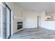 Living room view showcasing a fireplace, sliding door, and an open concept kitchen at 7414 S Alkire St # 101, Littleton, CO 80127