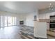 Bright living room with fireplace, wood-look flooring, and sliding glass doors to an outdoor space at 7414 S Alkire St # 101, Littleton, CO 80127