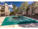 Community pool with evergreen trees and multi Gathering buildings in the background on a bright sunny day at 7414 S Alkire St # 101, Littleton, CO 80127