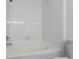 Bright white tiled tub and shower combo at 7414 S Alkire St # 101, Littleton, CO 80127
