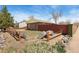 Home's backyard with wood fence, rock borders and mature landscaping at 902 Pacific Pl, Fort Lupton, CO 80621