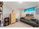 Well-lit bedroom showcasing a daybed, dresser, and modern lighting fixtures at 902 Pacific Pl, Fort Lupton, CO 80621
