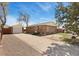 Charming brick home featuring a detached garage and spacious driveway at 902 Pacific Pl, Fort Lupton, CO 80621