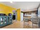 Open concept kitchen with hardwood floors connecting to a colorful living space at 902 Pacific Pl, Fort Lupton, CO 80621