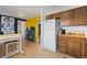 Open kitchen with stainless steel appliances, a dining table and ample storage space at 902 Pacific Pl, Fort Lupton, CO 80621