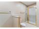 Bathroom features a shower with glass doors, white tile, and modern fixtures at 6000 W Floyd Ave # 116, Denver, CO 80227