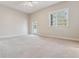 Cozy bedroom featuring a ceiling fan, window with natural light, and a private balcony at 6000 W Floyd Ave # 116, Denver, CO 80227