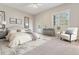 Bright bedroom with a queen-sized bed, neutral decor, and a door to a private balcony at 6000 W Floyd Ave # 116, Denver, CO 80227