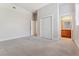 Empty bedroom with grey carpet and a view of the bathroom and closet at 6000 W Floyd Ave # 116, Denver, CO 80227