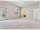 Bright bedroom with a ceiling fan, window and an exit to a balcony showcasing indoor/outdoor living at 6000 W Floyd Ave # 116, Denver, CO 80227
