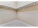 Corner of a walk-in closet showing ample storage space with rails for hanging clothes at 6000 W Floyd Ave # 116, Denver, CO 80227