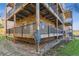Exterior view of the building showing wood decks, metal railings, and stone siding at 6000 W Floyd Ave # 116, Denver, CO 80227