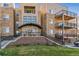 Attractive multi-story condo building features stone accents and private balconies at 6000 W Floyd Ave # 116, Denver, CO 80227