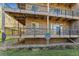Exterior shot of a building's lower deck with stone facade and black metal railings at 6000 W Floyd Ave # 116, Denver, CO 80227