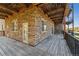 A view of a multi-level wooden deck with stone and wood accents and black railings at 6000 W Floyd Ave # 116, Denver, CO 80227