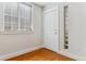 Foyer with hardwood floors, a door, a window, and an decorative glass block panel at 6000 W Floyd Ave # 116, Denver, CO 80227