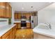 Charming kitchen features stainless steel appliances, wood cabinets, and a breakfast bar at 6000 W Floyd Ave # 116, Denver, CO 80227