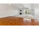 Spacious living room with fireplace, fan, and large windows overlooking the trees at 6000 W Floyd Ave # 116, Denver, CO 80227