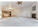 Open living area featuring a fireplace and connecting to a well-equipped kitchen at 6000 W Floyd Ave # 116, Denver, CO 80227