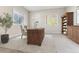 Comfortable office with natural light, built-in bookshelves, and a wooden executive desk at 6000 W Floyd Ave # 116, Denver, CO 80227