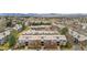 An aerial view of the condo buildings surrounded by mature trees at 3656 S Depew St # 102, Denver, CO 80235