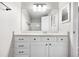 The bathroom features an updated vanity, large mirror, and modern fixtures at 3656 S Depew St # 102, Denver, CO 80235
