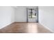 An empty bedroom with laminate wood flooring and lots of natural light from the window at 3656 S Depew St # 102, Denver, CO 80235