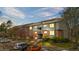 A landscaped exterior view of a multi-Gathering residence complex with parking, trees, and shrubbery at 3656 S Depew St # 102, Denver, CO 80235