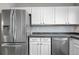 This kitchen features stainless steel appliances, modern cabinets, and a stylish backsplash at 3656 S Depew St # 102, Denver, CO 80235